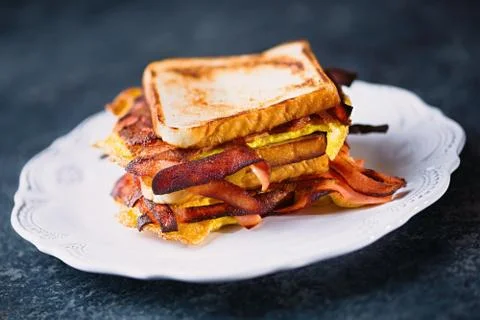 Breakfast ham, bacon and egg sandwich Stock Photos