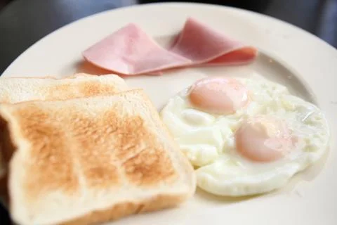 Breakfast with ham , fried egg and bread Stock Photos
