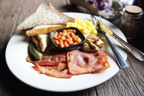 Breakfast with ham , fried egg and bread on wood background low key Stock Photos