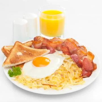 Breakfast hash browns bacon fried egg toast orange juice Stock Photos