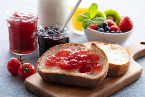 Breakfast image of bread, jam and fruit Stock Photos