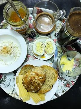 Breakfast includes freshly brewed coffee, orange jam, toast and eggs. Stock Photos