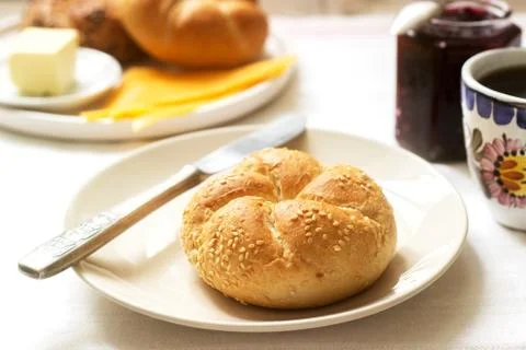 Breakfast with Kaiser rolls, currant jam, butter and cheese and tea. Stock Photos