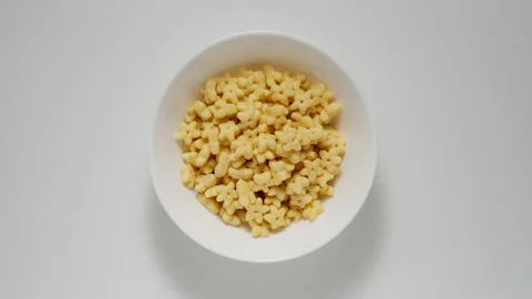 Breakfast kid corn flakes appear in white dish, stop motion Stockbeeldmateriaal 146370216