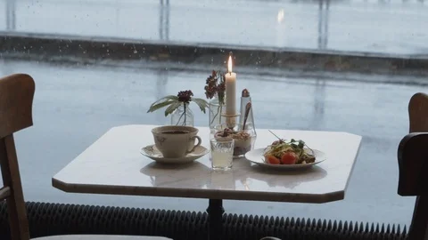 A breakfast on a lonely table at a café on a rainy day. 스톡 동영상 119738113