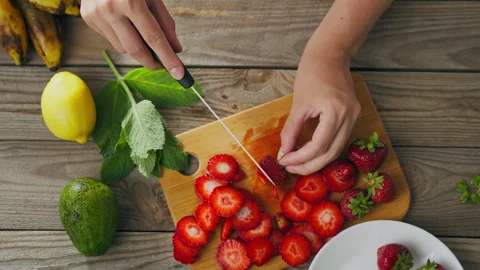 Breakfast, lunch, or snack preparation. Female hands, slice juicy strawberri 動画素材 246535255
