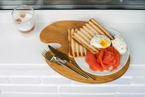 Breakfast menu: toasted bread, smoked salmon, poached eggs and cup of coffee Stock Photos