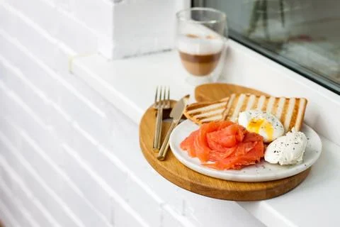 Breakfast menu: toasted bread, smoked salmon, poached eggs and cup of coffee Stock Photos
