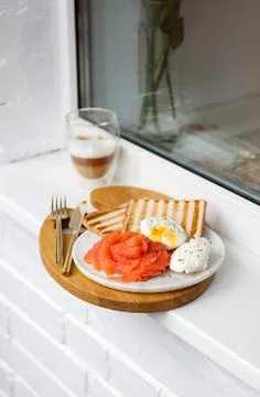 Breakfast menu: toasted bread, smoked salmon, poached eggs and cup of coffee Stock Photos