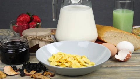 Breakfast. Milk, cornflakes, berries and yogurt Video stock 169998156