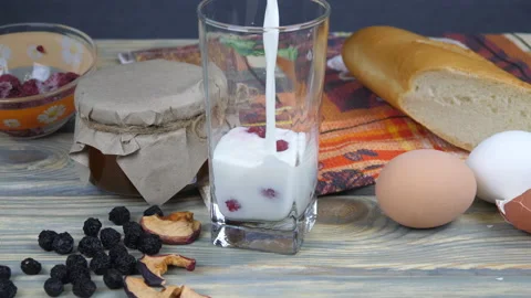 Breakfast. Milk, cornflakes, berries and yogurt Video stock 169998676