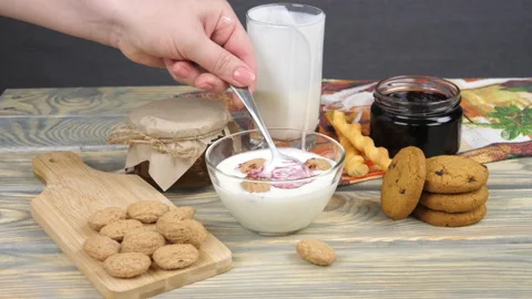 Breakfast. Milk, cornflakes, berries and yogurt Video stock 169999334