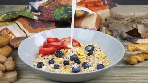 Breakfast. Milk, cornflakes, berries and yogurt Video stock 169999606