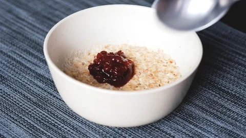Breakfast oatmeal with lingonberry jam Stock Footage 124134285