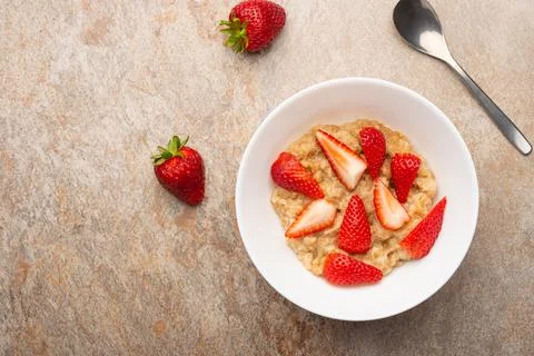 Breakfast of oatmeal with strawberries, flat lay Stock Photos