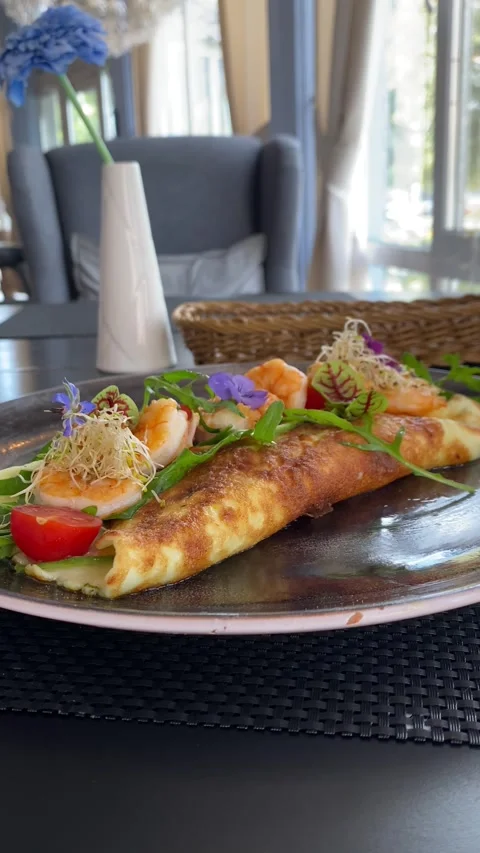 A breakfast omelet garnished with vegetables. Vertical video Stock Footage 281512890