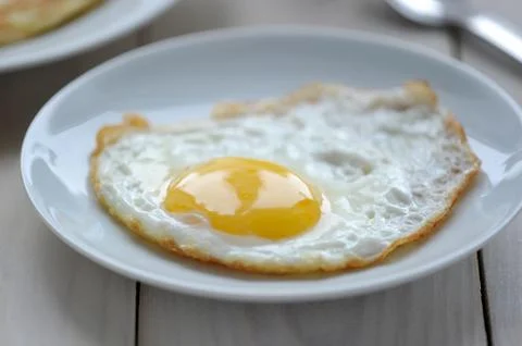 Breakfast one fried egg on a plate Stock Photos