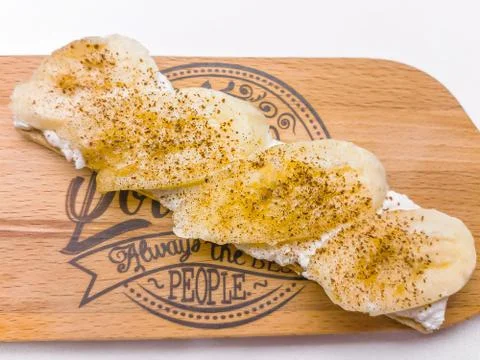 Breakfast open sandwich with soft cream cheese ricotta, banana, cinnamon Foto stock