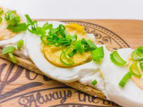 Breakfast open sandwich with soft cream cheese ricotta, egg, onion. Close up Stock Photos