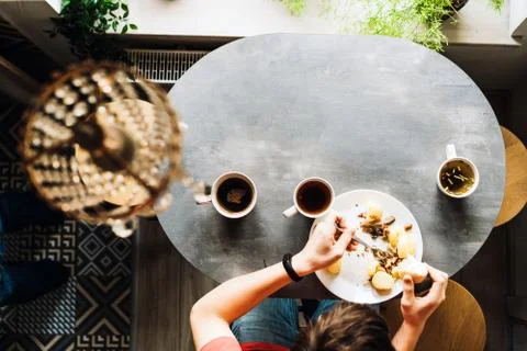 Breakfast at the oval table by the window. Stock Photos