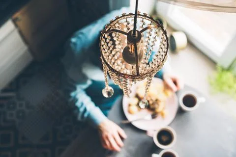 Breakfast at the oval table by the window. Stock Photos