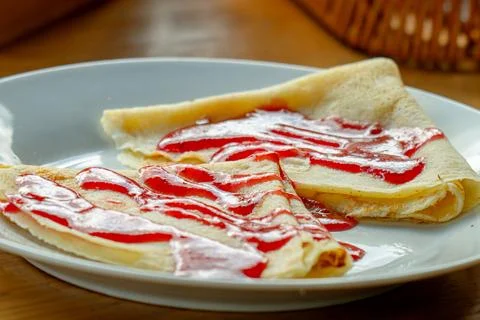 Breakfast with pancakes topped with raspberry jam Stock Photos