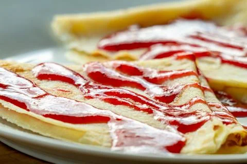 Breakfast with pancakes topped with raspberry jam Stock Photos