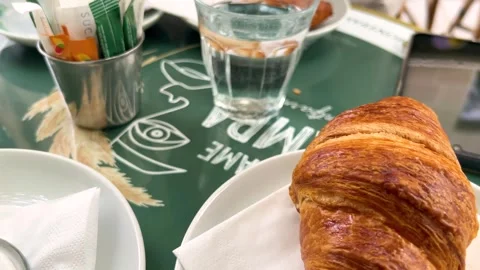 Breakfast in Paris. Flat white coffee and fresh croissant on the terrace. Vídeos de archivo 311932508