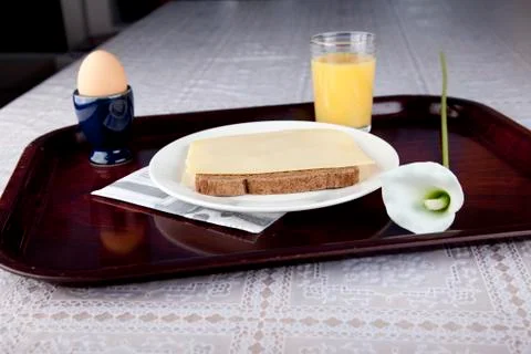 Breakfast on plate with bread, cheese, egg and orange jus Stock Photos