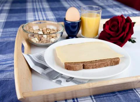 Breakfast on plate with bread, cheese, egg, cruesli and orange jus Stock Photos