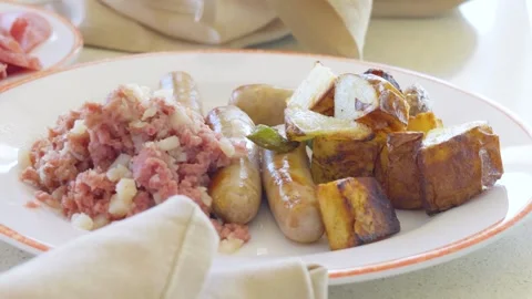 Breakfast plate with corned beef hash sausages and roasted potatoes Stock-Footage 338202331