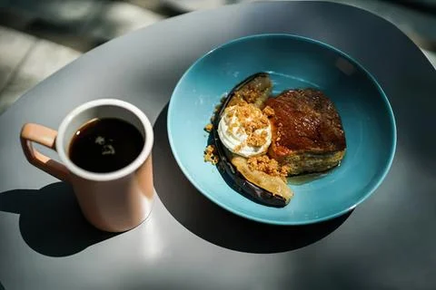 Breakfast plate with fried egg toast tomatoes and coffee Stock Photos