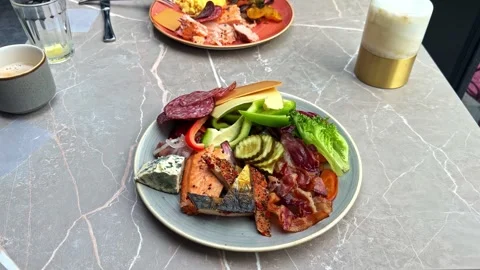 Breakfast Plate with Salmon Bacon Cheese and Fresh Vegetables on Marble Table Stock Footage 340306191