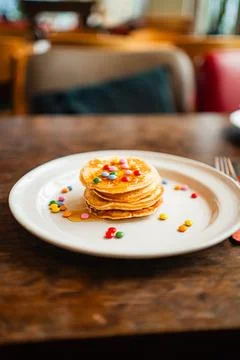 Breakfast Plate with Small Stack of Glossy Pancakes Topped with Chocolate L.. Stock Photos