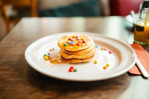 Breakfast Plate with Small Stack of Pancakes Topped with Colorful Chocolate.. Stock Photos