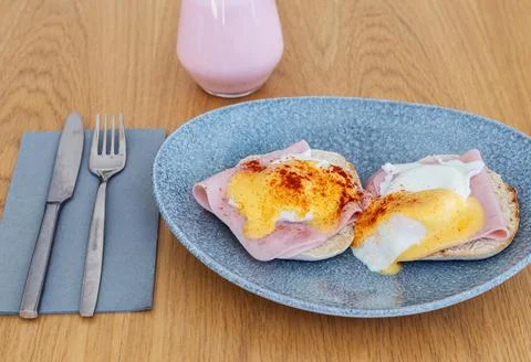 Breakfast plate with two pieces of bread toast topped with ham and fried egg Stock Photos