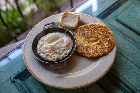 Breakfast platter with a corn cake with cheese and two fried eggs on a smal.. Stock Photos