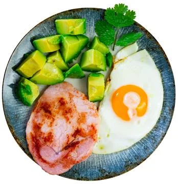 Breakfast: pork, avocado, scrambled eggs and buckwheat Stock Photos