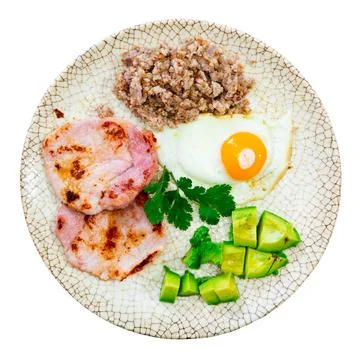 Breakfast: pork, avocado, scrambled eggs and buckwheat Stock Photos