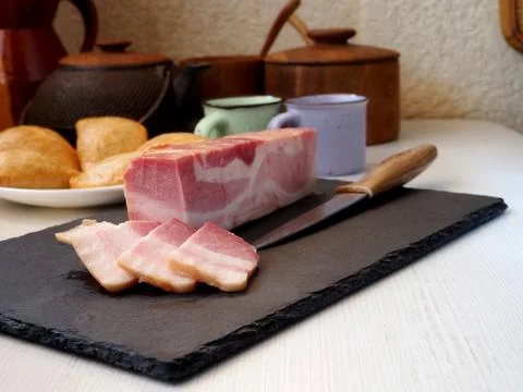 Breakfast preparation. Bacon and bread Stock Photos