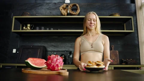 Breakfast in the private kitchen with dark colors. Young woman woke up Stock Footage 237699060