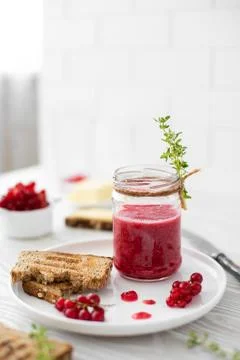 Breakfast with redcurrant jam, rye bread and butter Stock Photos