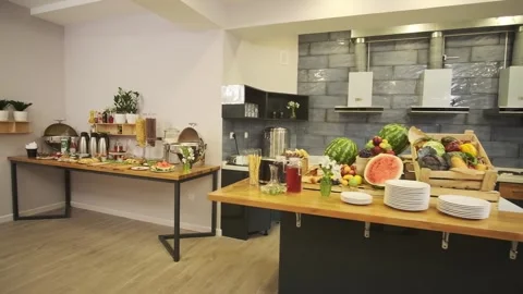 Breakfast room in a small hotel. Served table with sausages, meat, salads Stock Footage 255766819
