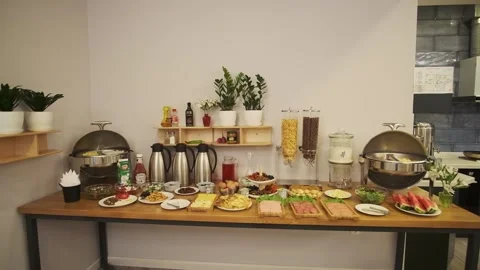 Breakfast room in a small hotel. Served table with sausages, meat, salads Stock Footage 277332474