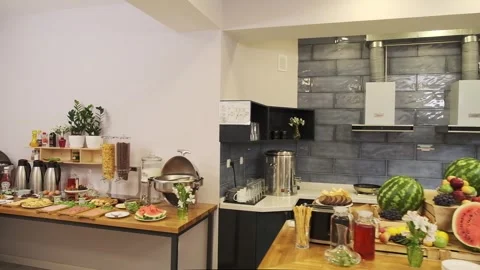 Breakfast room in a small hotel. Served table with sausages, meat, salads Stock Footage 310315073