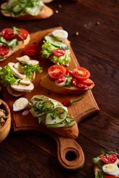 Breakfast sandwich with homemade paste, vegetables and fresh greens, shallow Stock Photos