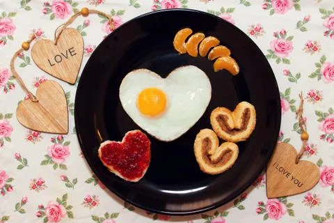 Breakfast with scrambled egg in a heart shape. Valentine's Day Stock Photos