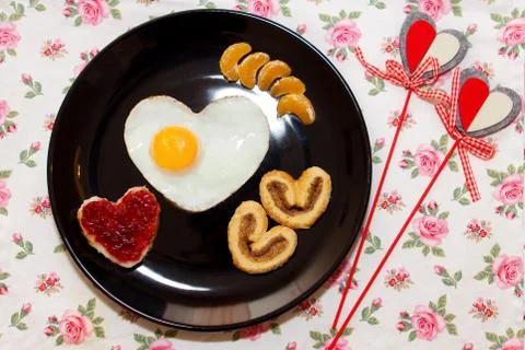 Breakfast with scrambled egg in a heart shape. Valentine's Day Stock Photos