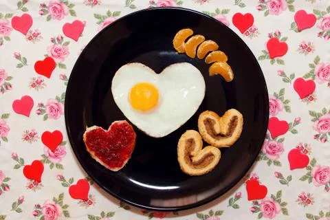 Breakfast with scrambled egg in a heart shape. Valentine's Day Stock Photos