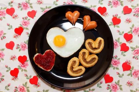Breakfast with scrambled egg in a heart shape. Valentine's Day Stock Photos